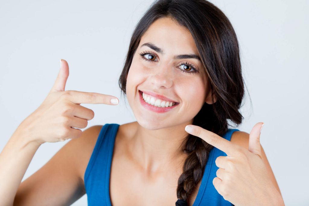 woman smiling after getting veneers in fort pierce
