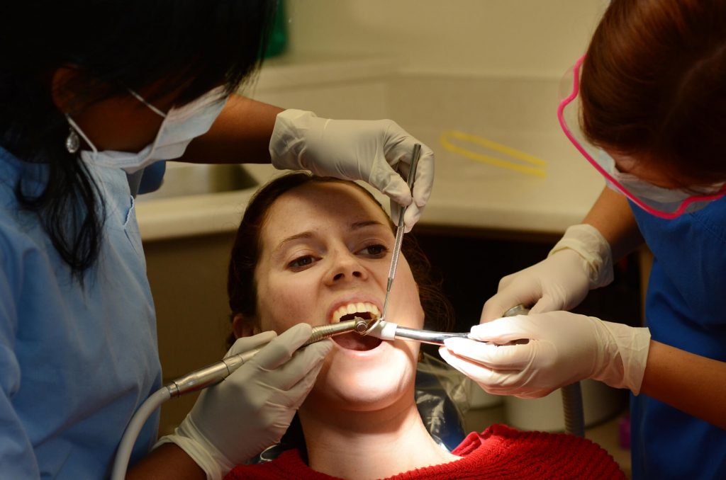 Emergency Dentist in Fort Pierce checks female patient